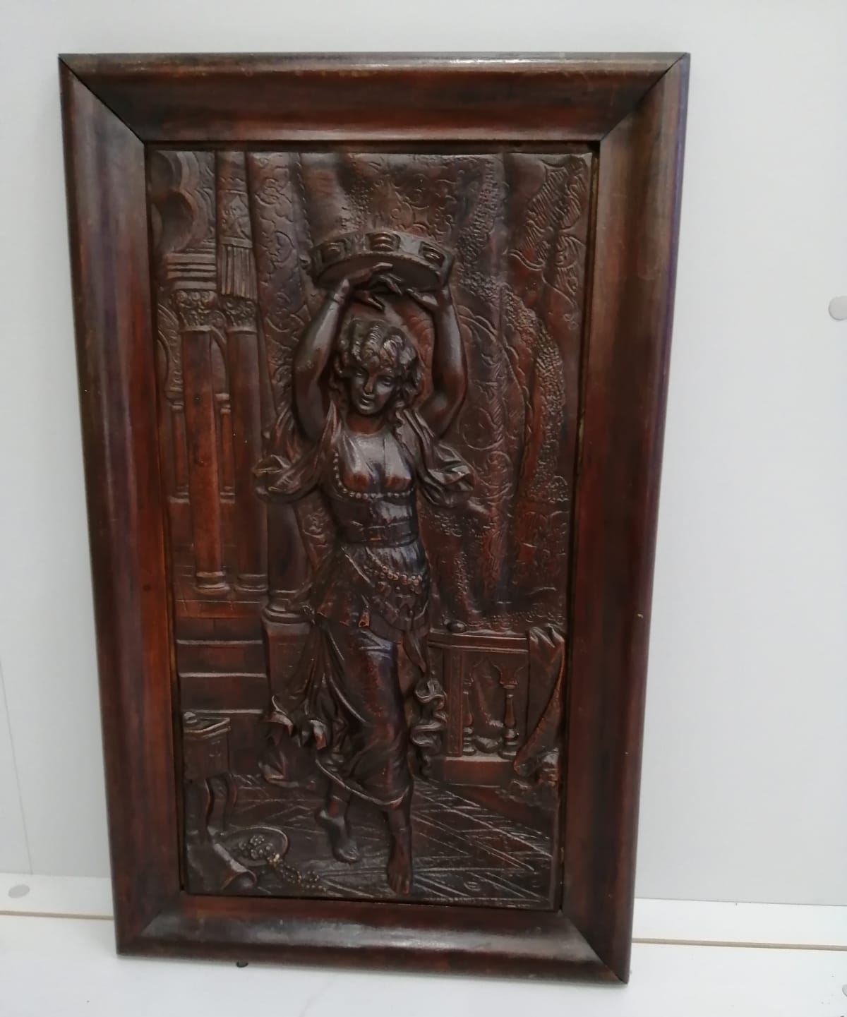 A rectangular carved wood relief plaque depicting a female dancer with tambourine, width 37cm, height 60cm